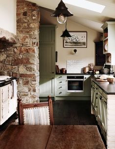 an old fashioned kitchen with green cabinets and wood flooring is pictured in this image