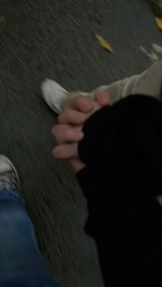 two people standing next to each other with their hands on one another's feet