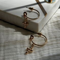 CROSS DROP HOOP EARRINGS IN GOLD SHADE These Cross Drop Hoop Earrings in an elegant gold shade beautifully merge the classic charm of the Old Money aesthetic with a touch of modern coquette flair. The perfect gift for her, these earrings are both stylish and meaningful, featuring a dainty cross pendant that dangles gracefully from sleek hoops. Ideal for adding a sophisticated statement to any outfit, these earrings blend the timeless appeal of hoop earrings with the spiritual symbolism of cross Earrings For Mom, Dainty Dangle Earrings, Dainty Coquette, Christmas Gift Daughter, Drop Hoop Earrings, Cute Gifts For Her, Sister Wife, Girlfriend Birthday, Money Aesthetic