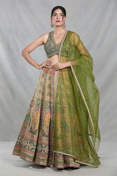 Multi color banarasi silk lehenga with all over Royal mahal woven details. Paired with a sleeveless V neck forest green blouse with floral embroidery using sequin, cutdana highlights and an organza dupatta with sequin work. - Aza Fashions Silk Lehenga With Pallu, Transitional Green Tissue Silk Lehenga, Transitional Green Silk Lehenga, Transitional Season Green Silk Lehenga, Pista Green Chanderi Lehenga For Navratri, Silk Meenakari Choli For Reception, Navratri Pista Green Silk Choli, Fitted Chanderi Lehenga With Meenakari, Silk Meenakari Anarkali Set For Reception