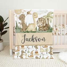 a baby crib bedding set with an animal theme and name on the cover