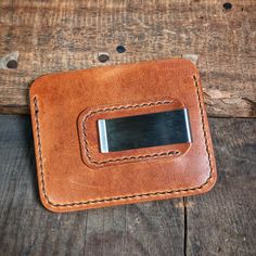 The "Riley" wallet is a must-have for anyone who wants to keep their things organized. It's made from world-famous Horween leather which makes it strong and good-looking. The leather will change color over time and look even better.On the front of the wallet, there are two pockets to put your cards in and a little pocket on top for extra cards. You can put your ID, credit cards, and business cards in these pockets. And the pockets can hold more cards as you use the wallet more.The money clip on Rectangular Wallets With Leather Lining For Everyday Carry, Classic Bifold Wallet For Personal Use, Classic Rectangular Trifold Wallet For Personal Use, Brown Rfid Blocking Wallet For Personal Use, Classic Bifold Wallet With Leather Patch, Leather Wallets With Card Slots For Everyday Use, Everyday Rectangular Trifold Wallet With Coin Pocket, Modern Rectangular Wallet For Everyday Carry, Rectangular Rfid Blocking Wallets For Everyday Use