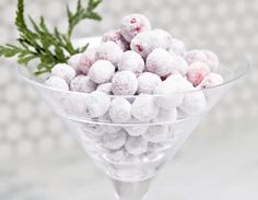 a martini glass filled with powdered sugarballs and sprig of parsley