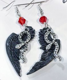 I am in love with Good Omens. Crowley and Aziraphale are the best so I had to make them earrings, you can choose crowley black wings, Aziraphale is white and I have a mix of both of them if you would like. The wings measure about two inches but are very light. Good Omens Earrings, Gothic Winged Jewelry Gift, Gothic Winged Jewelry For Gifts, Good Omens Jewelry, Black Fantasy Dangle Jewelry, Black Fantasy Earrings, Black Fantasy Style Pierced Earrings, Black Fantasy Style Earrings, Black Wing-shaped Jewelry Gift