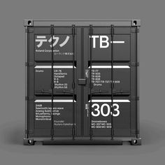 two black shipping containers sitting side by side on top of each other, with the words tb printed on them