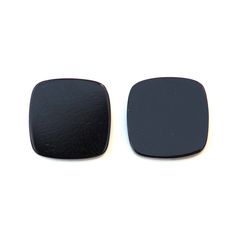 two black square buttons sitting on top of each other