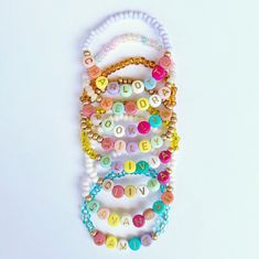 💕YOU'LL RECEIVE: One (1) beaded stretch bracelet, with the name or phrase of your choice. Letter beads are multi-colored with gold font. The colors of the letters will be selected at random. All bracelets will be made with a single Bronze Gold accent bead on either side of the letter beads, unless otherwise noted. 💕CARE: Jewelry is not meant to be overly stretched. Excessive force or pulling/tugging may result in breakage. Items contain small parts, which could pose as a choking hazard. Never Letter Bead Bracelet, Letter Bead Bracelets, Gold Font, Bracelet For Girls, Wearing Jewelry, Custom Kids, Jewelry Personalized, Bronze Gold, Letter Beads