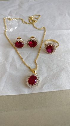 Classic Diana ring, earrings and pendant with chain set made with lab created synthetic Ruby cut and best 5A quality cubic zirconia. synthetic Ruby we have used is of exact same cut, color and quality as of natural ruby. Length of chain is adjustable from 16" inches to 18" inches. Ruby Cut - 9 mm x 11 mm Zirconia - 2.5 mm All  of our products are 100% skin-friendly and eco-friendly, does not contain nickel, cadmium, or lead. Base metal is guaranteed silver 925, stamped and marked and is real 18k White or Yellow gold filled which is very durable and stays for years. Gold Filling is completely different from Gold Plating as gold filling contains 100% gold which does not go away easily and enhances the life and look of the jewelry. Crystal Rings Hand Set As Gift, Ruby Jewelry Sets As Gift, Hallmarked Ruby Jewelry Sets For Gift, Oval Cubic Zirconia Jewelry Sets For Formal Events, Oval Cubic Zirconia Jewelry Set For Anniversary, Oval Cubic Zirconia Jewelry Sets For Formal Occasions, Formal Oval Cubic Zirconia Jewelry Sets, Dazzling Ruby Jewelry With Halo Setting, Ruby Jewelry Sets With Sparkling Stones For Gifts