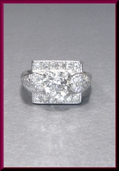 Set in platinum his ring envelopes with impassioned elegance the heart of the 1930's. It holds a 1.20 ct old European cut diamond in the center. The diamond is a K in color and VS2 in clarity. An effervescent orb of dazzle surrounds the center with another .65 ct of 22 cascading accent round diamonds for a piece of seductive extravagance. We offer resizing, free of charge. ER 494S SIX MONTH LAY-AWAY AVAILABLE - PLEASE CONTACT ME TO SET UP A PLAN Art Deco Gia Certified Diamond Ring For Formal Occasions, Vintage Gia Certified Diamond Ring Gift, Vintage Gia Certified White Gold Diamond Ring, Vintage Gia Certified White Diamond Ring, Gia Certified Vintage White Gold Jewelry, Vintage Gia Certified White Gold Jewelry, White Vintage Princess Cut Jewelry, Vintage Gia Certified Diamond White Diamond Ring, Vintage Gia Certified Jewelry For Anniversary