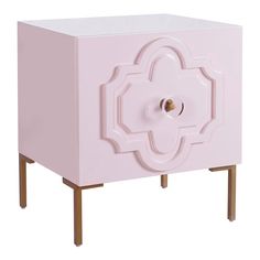 a pink cabinet with an intricate design on the front and bottom, against a white background