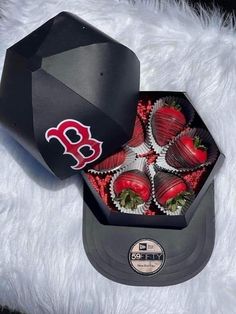 a box filled with chocolate covered strawberries on top of a white furnishing