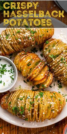 crispy hasselback potatoes on a white plate with ranch dip and parsley