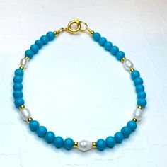 Pretty Simply Stated Piece Made With Magnesite, Fresh Water Pearls And 14k Gold Filled Beads. Made With A Gold Spring Ring Clasp. Elegant Blue Rondelle Bracelets, Blue Pearl Bracelet With Gemstone Beads For Gift, Blue Pearl Bracelet With Gemstone Beads As A Gift, Elegant Single Strand Turquoise Bracelet, Dainty Blue Rondelle Jewelry, Elegant Blue Hand-strung Jewelry, Turquoise Single Strand Bracelet Gift, Turquoise Single Strand Bracelet As Gift, Turquoise Single Strand Bracelet For Gift