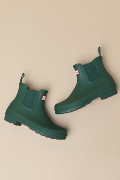 Romanticize rainy days with every step in the Hunter Original Hunter Green Chelsea Rain Boots! These matte rubber rain boots feature a rounded upper that rises to an ankle-high shaft with elastic gussets at the instep and outstep. The slip-on design features a pull tab and a ribbed-textured detail at the back, all atop a sturdy low-block heel. Logo tag at the front. Available in whole sizes only. 0. 75" rubber heel. Lightly cushioned insole. Rubber sole has nonskid markings. Man made materials. Rain Boot Outfit, Short Rain Boots, Chelsea Rain Boots, Oc Inspo, The Hunter, Low Block Heels, Logo Tag, Rubber Heels, Boots Outfit