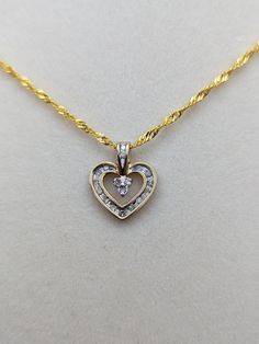 "10k Ladies Yellow Gold & Diamond Heart Shaped Pendant  Complimentary 18\" GF 18k chain included. This beautiful diamond heart will make a wonderful present. Condition: Vintage, minimal signs of wear to its age Tested at 10k pendant  Pendant: 10K Yellow Gold   16.5 mm height by 13.8 mm width Gemstone: 18 Diamonds 1.2 mm All our jewelry is properly washed and disinfected to ensure customers get clean items with every order. Comes in a Gift Box" 14k Gold Heart Pendant Diamond Necklace For Anniversary, Gold Heart Cut Brilliant Diamond Necklace, Yellow Gold Heart Pendant Diamond Necklace, Diamond Cut Yellow Gold Heart Necklace, Yellow Gold Double Heart Diamond Necklace With Accents, Gold Heart-shaped Brilliant Cut Diamond Necklace, Anniversary Heart Pendant Diamond Necklace With 17 Jewels, Gold Diamond Cut Necklace For Valentine's Day, Classic Diamond Cut Heart Necklace For Anniversary