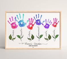 three handprints with the names of each child's hands and flowers on them