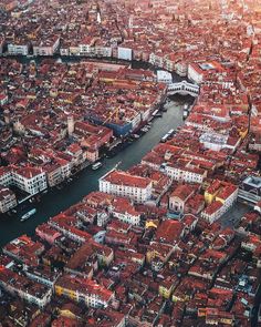 an aerial view of venice, italy with red roofs and water in the foreground