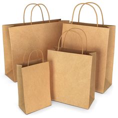 four brown paper bags with handles on white background