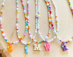 These fun custom initial necklaces are perfect for any occasion! mommy and me, bachelorette gifts, bridal party or just a gift for yourself! I have a fun variety of colors for the letters! If you would like a larger quantity please feel free to message me! :) Birthday Initial Pendant Necklace With Letter Beads, Personalized Multicolor Initial Pendant Jewelry, White Initial Pendant Charm Necklaces With Letter Beads, White Initial Pendant Charm Necklace With Letter Beads, Birthday Necklace With Initial Pendant And Letter Beads, White Initial Pendant Charm Necklace, White Fun Necklaces With Letter Beads, Fun Letter Beads Jewelry For Birthday, Personalized Initial Pendant Name Necklace With Letter Beads