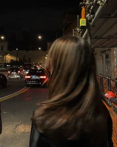 a woman walking down the street at night