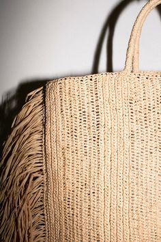 Raffina tote with woven handles, and 12" draped fringe at sides. Tote measures 14.5" wide (without fringe), 16" tall and 4" in depth. Handcrafted in France. Beige Fringe Shoulder Bag For Shopping, Chic Straw Tote Bag With Tassels, Rectangular Natural Shoulder Bag With Fringe, Chic Straw Bag With Fringe, Chic Beige Straw Bag With Fringe, Natural Shoulder Bag With Tassels For Shopping, Natural Fringe Rectangular Shoulder Bag, Shopping Fringe Straw Tote Bag, Fringe Straw Tote Bag For Shopping