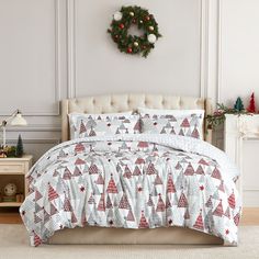 a bed with christmas trees on it in a room