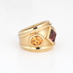 This is part of Chairish’s Fine Jewelry assortment.  Estate David Yurman Renaissance ring crafted in 18 karat yellow.    The out of production David Yurman ring is set with a center set Rhodolite garnet measuring 6mm. Two citrines measure 7mm x 5.5mm. The gemstones are in very good condition and free of cracks or chips. Weighing a hefty 16.6 grams the ring makes a great statement on the hand. The ring has a medium rise (6.5mm - 0.25 inches).  The ring is in very good condition and was recently l Yurman Ring, David Yurman Ring, Ruby Bands, Van Cleef And Arpels, Wide Band Ring, Contemporary Ring, Purple Band, Ring Crafts, Wide Band Rings