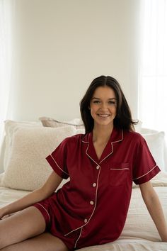 Description Our Burgundy Satin Pajamas are made from a luxuriously soft satin blend fabric. With a spandex component, these pjs allow for added flexibility and comfort, making them perfectly lightweight and breathable for bedtime. Featuring elevated design details like beautiful pearlescent shell buttons, cuffed hems, and contrast piping trim. Add a personalized touch with our custom printed text option, making these pajamas the perfect gift for a loved one or keepsake for your own sleepwear col Wedding Pjs, Pajamas Shorts Set, Party Pajamas, Bridal Party Pajamas, Pajamas Silk, Silk Pajamas Shorts, Pajamas Shorts, Bridesmaid Pajamas, Monogrammed Pajamas