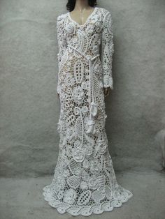 a white crocheted dress is displayed on a mannequin