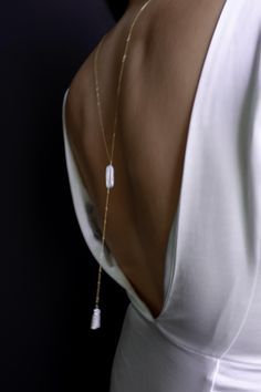 This simple and dainty back drop necklace features two freshwater biwa pearls and looks great with backless tops and dresses. There is no clasp, it is completely reversible, so you can wear it in the front over a sweater or tee. So lightweight - you won't even know it's on! "BIWA FRESHWATER PEARL BACK DROP NECKLACE" by GoldenLinings - Christine Elizabeth Jewelry D E T A I L S Materials: 14K Gold Fill or Sterling Silver S I Z E S Measures 26" (so you can put it over your head) Drop measures: approx 4" M A T E R I A L S With so many terms to describe gold jewelry, it can be confusing to know exactly what you're buying and how to care for it. Gold fill contains 100+ times more real gold than gold-plated jewelry. It is heat bonded, making it more durable than gold-plated jewelry. It's a great Christine Elizabeth Jewelry, Bridal Jewelry Simple, Christine Elizabeth, Jewelry Minimal, Simple Bride, Elizabeth Jewelry, Star And Moon Necklace, Backdrops Necklace, Biwa Pearls