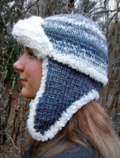 a woman wearing a blue and white knitted hat