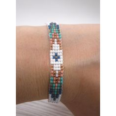 a woman's arm with a bracelet made out of beads