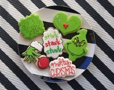 some cookies that are on a plate with the words stink, stink, and another christmas cookie