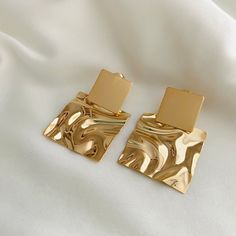 These beautiful hammered earrings are a unique piece of jewelry. It combines them with an elegant outfit, ideal for going to parties and meeting with friends. They have a beautiful design and give you a perfect touch of beauty in your outfits! They are available in Gold Filled and Rhodium for your best choice. Material: 18k Gold Filled - Size:38 x 27mm -Perfect for all time. -High-quality Hoops! FAST & FREE SHIPPING! Our handmade products are rated very highly by our customers. We work hard with Modern Hammered Earrings For Party, Modern Hammered Earrings For Parties, Chic Hammered Metal Earrings, Elegant Hammered Rectangular Earrings, Elegant Rectangular Hammered Earrings, Rectangular Earrings, Earrings Square, Going For Gold, Hammered Earrings