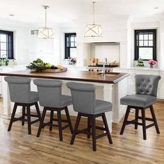 a kitchen with an island and four stools