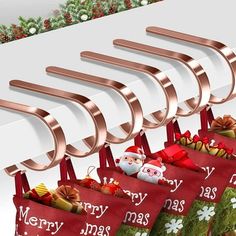 four christmas stockings hanging from hooks on a wall