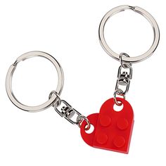 a red heart shaped keychain on a white background