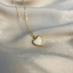 Looking for a necklace that's both pretty and meaningful? Check out our heart charm necklace! The pendant is made from white agate, which is known as a symbol of calm and balance. It's 18k gold plated for a touch of luxury and comes on a delicate chain. Whether you're treating yourself or looking for a gift for someone special, this crystal necklace is sure to please. White agate is a powerful stone that can represent a sense of safety and security.  White Agate is a great stone for crystal begi White Minimalist Jewelry With Heart Charm, Minimalist White Heart Charm Jewelry, Dainty White Jewelry With Heart Charm, White Heart Charm Jewelry For Everyday, Dainty White Heart Pendant Jewelry, White Hypoallergenic Heart-shaped Jewelry, White Sterling Silver Charm Necklace With Heart Charm, Everyday White Heart Necklace With Delicate Chain, Dainty White Heart Pendant Necklace