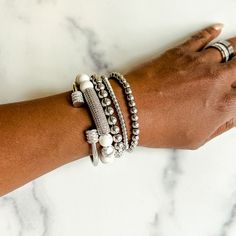 Add extra dazzle to your outfit with this gorgeous stack of bracelets. With a mix of delicate and bold pieces, sparkly rhinestones and glimmering metallics, the Annabella bracelet stack has everything you need to dress up any look. This bracelet stack includes: - Terri stainless steel and rhinestone cuff bangle - Tanisha howlite beaded bracelet with rhinestone bar - 2 Nakia stainless steel beaded bracelets (6mm and 8mm) - Nyoki stainless steel bracelet This bracelet stack will fit wrists up to 7 Bracelet Stack Ideas, Amine Girl, Stack Of Bracelets, Weekly Workouts, Horseshoe Bracelet, Long Bracelet, Stacked Earrings, Heart Hoop Earrings, Cuff Bangle Bracelet