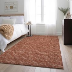 an orange rug in a bedroom with white walls