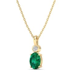 This exquisite oval-shaped emerald pendant is a true statement piece, exuding elegance and sophistication. Crafted with precision and attention to detail, the emerald is surrounded by sparkling diamonds, adding a touch of luxury to the design. Metal: 14K Gold Setting Type: Prong Rhodium Finish: Yes, on White Gold Gemstone Details: Gemstone: Emerald Shape: Oval Average Dimensions: 7.00 x 5.00 MM Quantity: 01 Average Cut: Very Good Average Color: Medium to Dark Green Average Clarity: Eye Clean Nat Elegant Oval Emerald Necklace In Yellow Gold, Oval Emerald Necklace With Diamond Accents, Oval Green Emerald Necklace With Diamond Accents, Oval Emerald Necklace In Yellow Gold, Fine Jewelry Emerald Necklace With Oval Diamond Pendant, Fine Jewelry Diamond Emerald Necklace With Oval Pendant, Emerald Necklace With Diamond Oval Pendant, Fine Jewelry, Elegant Oval Emerald Necklace With Bezel Setting, Elegant Yellow Gold Oval Pendant Emerald Necklace