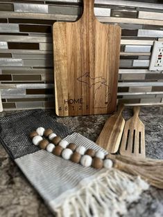 wooden utensils and cutting board sitting on top of a counter