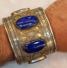 Origin Afghanistan Wonderful Old Silver Vintage Bangle Gold-plated On Top made by Hand in Afghanistan with Beautiful Natural Lapis lazuli Stone Adjustable Blue Engraved Cuff Bracelet, Blue Ceremonial Bangle Jewelry, Blue Ceremonial Bangle, Blue Ceremonial Bracelet Jewelry, Ceremonial Blue Bracelet Jewelry, Artisan Blue Engraved Cuff Bracelet, Artisan Engraved Blue Bracelets, Unique Engraved Blue Bracelets, Blue Bracelet With Intricate Design As A Gift