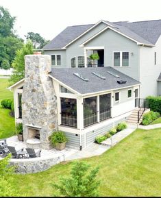 an aerial view of a house with a patio and fire place in the front yard