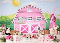 there are many stuffed animals on display in front of a pink barn and windmill backdrop