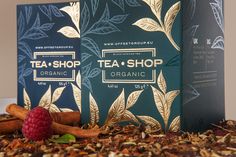 two boxes of tea shop organic with raspberries and cinnamons on the ground