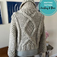 a knitted jacket sitting on top of a chair