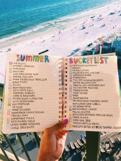 someone holding up a summer bucket list on the balcony of their beachfront condos