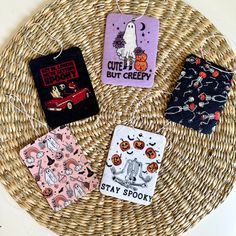 four halloween cards are sitting on a wicker basket