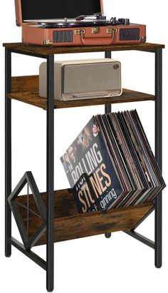 an old record player is sitting on top of a shelf with vinyl records and magazines